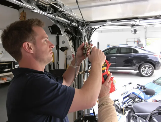 Berea Garage Door Repair safety certified technician performing cable replacement in Berea